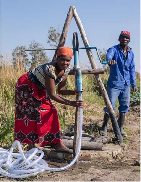IMAGE 4: Farmers in Malawi using a rope and washer irrigation pump. (Image courtesy of Pump Aid)
