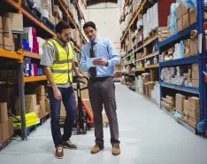 Manager and worker in a warehouse